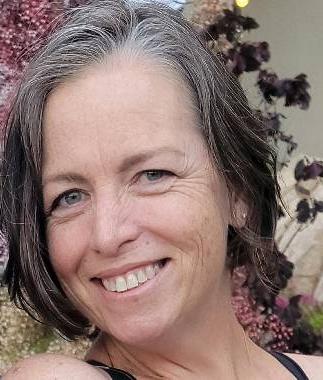 woman with short gray hair with flower background